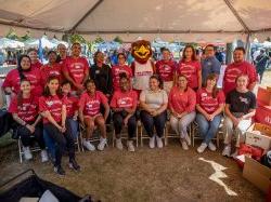 Staff and students from the College for Community Health and the Office of Community Engagement & Partnerships pose for a group picture with Rocky.